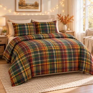 May include: A bedding set featuring a plaid pattern in shades of forest green, deep red, mustard yellow, and navy blue. The set includes a comforter and two matching rectangular pillow shams, all displaying the same multi-coloured tartan design.