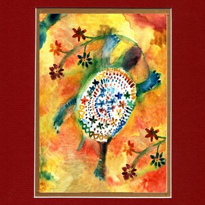 May include: Watercolor painting of a turtle with a patterned shell in shades of white, blue, and orange. The turtle is set against a vibrant yellow and orange background with floral accents. The artwork is framed with a white mat and a red border.