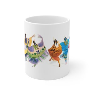 May include: White ceramic mug with a colorful illustration of five people in traditional clothing dancing. The people are wearing vibrant colors, including purple, green, yellow, orange, and blue.
