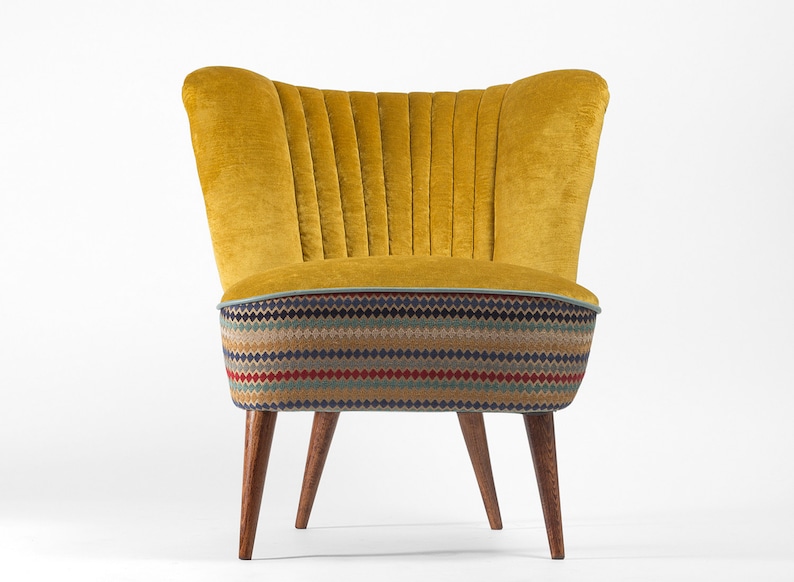 May include: A yellow velvet armchair with a patterned fabric seat and wooden legs.