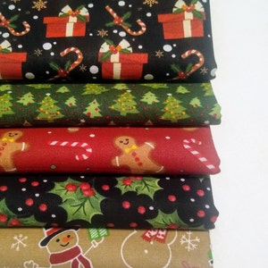 May include: A stack of six different Christmas-themed fabric prints. The top print features red and white presents, candy canes, and snowflakes on a black background. The second print features green Christmas trees on a white background. The third print features red candy canes and gingerbread men on a red background. The fourth print features green holly leaves and red berries on a black background. The fifth print features snowmen and presents on a tan background. The bottom print features a white snowflake pattern on a brown background.