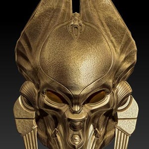 May include: A detailed, gold-coloured mask with a textured surface and intricate design. The mask features stylized eyes, a prominent nose, and two vertical, rectangular elements on either side. The overall aesthetic suggests a historical or fantasy theme.