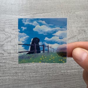 May include: A black silhouette of a figure standing by a wooden fence with yellow flowers in the foreground. The background is a blue sky with white clouds.