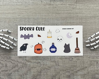 May include: A sheet of spooky cute Halloween stickers featuring a black crow, a pumpkin, a bat, a ghost, a candle, a skull, a cat, a crescent moon, a broom, and leaves. The sheet is white with black text that reads "Spooky Cute" and "Stacey-Doman-Art".