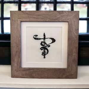 Hand embroidered Sword image in a 6.5"x6.5" wood frame with matting. Tabletop or wall hanging
