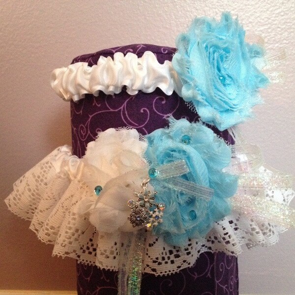 Blue and white shabby flower garter set with sparkly snowflake/flower charm, blue crystals, and candy swirl lace