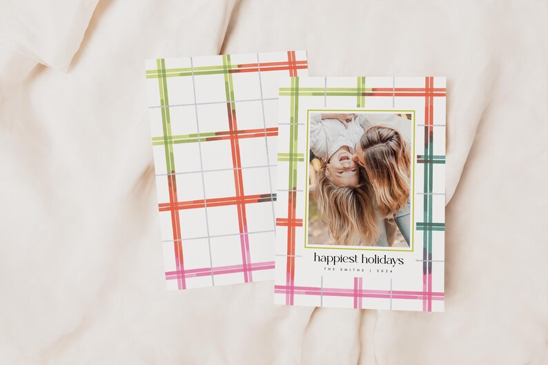 May include: Holiday greeting cards with a plaid pattern in green, red, and pink. One card features a photo of two people and the text "happiest holidays". The cards are on a white background.