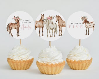 May include: Three round cupcake toppers with watercolor illustrations of horses wearing flower crowns. The toppers say "Happy Birthday Amelia" and "Amelia is Five".