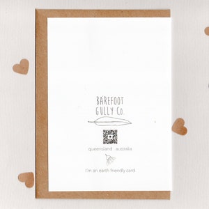 May include: A white card with black text that reads "BAREFOOT GULLY CO." and a QR code. The text "queensland. australia" is below the QR code. The text "I'm an earth friendly card" is at the bottom of the card.