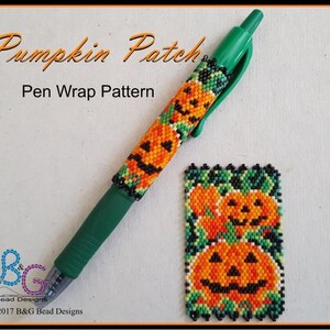 May include: A green pen with a beaded pen wrap featuring a pattern of orange pumpkins with black eyes and mouths, and green leaves. The pen wrap is titled "Pumpkin Patch Pen Wrap Pattern".