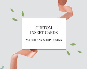 May include: A white card with the text "CUSTOM INSERT CARDS MATCH ANY SHOP DESIGN" and the text "shop ICONICA.com" at the bottom. The card is surrounded by a peach-colored ribbon and green leaves.