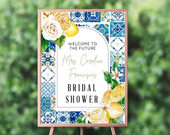 May include: A welcome sign for a bridal shower with a blue and white tile pattern, lemons, and flowers. The sign says "Welcome to the future Mrs. Caroline Francisco's Bridal Shower".