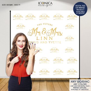 May include: White backdrop with gold text that reads "The Future Mr. & Mrs. Linn David and Yvette". The text is repeated in a smaller size throughout the backdrop.