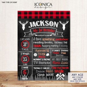 May include: A chalkboard-style birthday sign with a red and black plaid top border. The sign features the name "Jackson" and details about the child's first birthday, including height (31 inches) and weight (23 lbs).