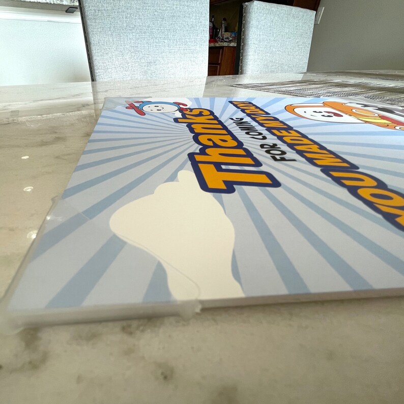 May include: A blue and yellow thank you sign with a white cloud and the text "You made my party! Thanks for coming!"