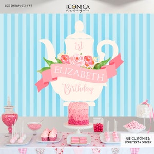 May include: A blue and white striped backdrop with a large white teapot decorated with pink flowers and a pink ribbon. The teapot has the text "1st ELIZABETH Birthday" on it. The backdrop is 6 feet wide by 4 feet tall.