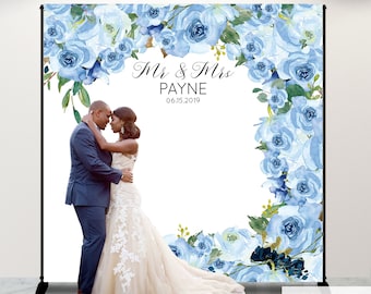 May include: A wedding backdrop with a blue floral design. The backdrop features a white background with a blue floral border. The text "Mr & Mrs PAYNE 06.15.2019" is printed in black at the top of the backdrop.