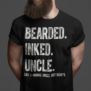 May include: A black t-shirt with white text that reads "Bearded. Inked. Uncle. Like a normal uncle, but bada*s."
