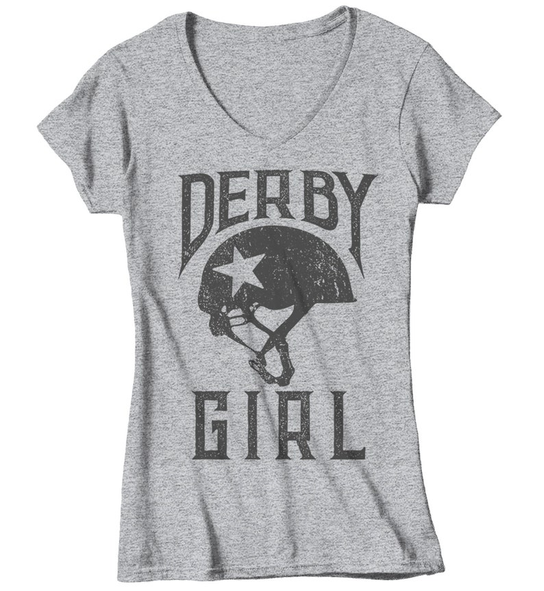 May include: Gray V-neck t-shirt with a distressed black graphic of a roller derby helmet with a star and the text "Derby Girl".