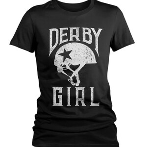 May include: Black t-shirt with a white graphic of a roller derby helmet with a star and the text "Derby Girl".