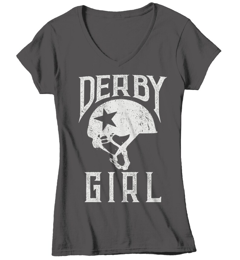 May include: A dark gray V-neck t-shirt with a white graphic of a roller derby helmet and the text "Derby Girl".