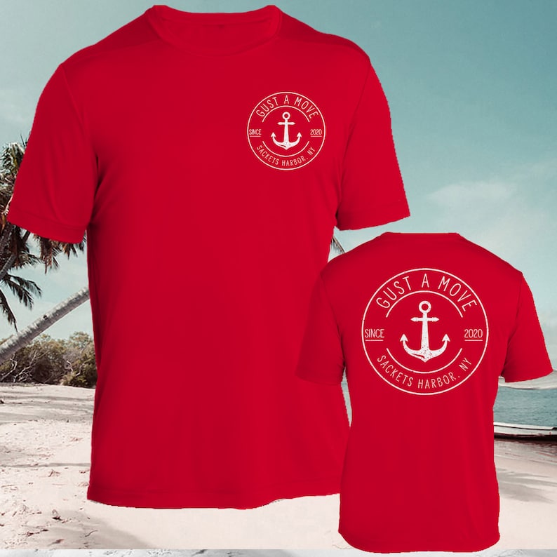 May include: Red t-shirt with a white circle logo on the front and back. The logo says "GUST A MOVE" with an anchor and the text "SINCE 2020 SACKETS HARBOR, NY".