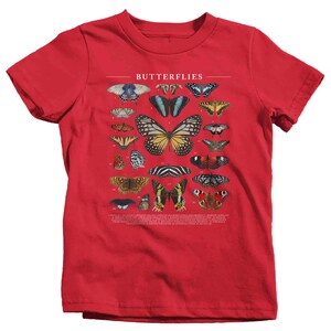 May include: Red t-shirt with a graphic of various butterflies and the word "Butterflies" printed on the front.