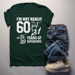 May include: A green t-shirt with white text that reads "I'm not really 60 I am just 21 with 39 years of experience".