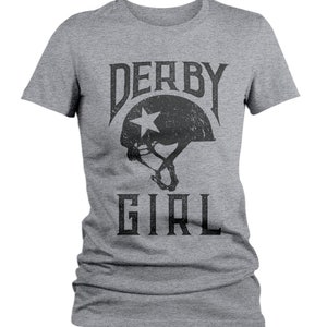May include: Gray t-shirt with a black graphic of a roller derby helmet with a star and the text "DERBY GIRL".