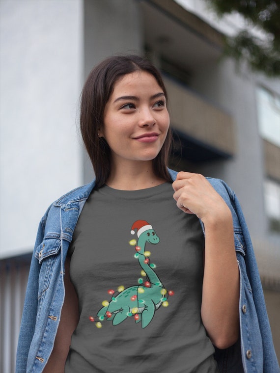 Women's Christmas Shirt Loch Ness XMas Lights T Shirt Cute Tee Tree Lights Santa Hat Dinosaur Dino Holiday Funny Graphic Tshirt Ladies