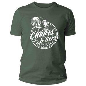 May include: A dark green t-shirt with a white graphic of a skeleton wearing a cap and holding a beer mug. The graphic is inside a circle with the words "Cheers & Beers To My 30 Years".