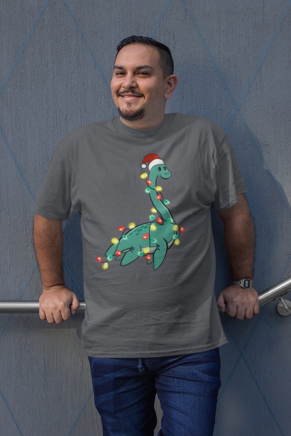 Men's Christmas Shirt Loch Ness XMas Lights T Shirt Cute Tee Tree Lights Santa Hat Dinosaur Dino Holiday Funny Graphic Tshirt Unisex Man