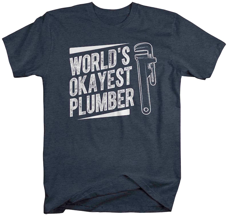May include: A dark blue t-shirt with white text that reads "World's Okayest Plumber" and a white wrench graphic.