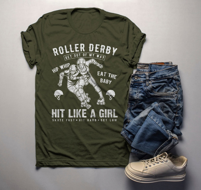 May include: A green t-shirt with a white graphic of two roller derby players. The text on the shirt reads "Roller Derby Get Out Of My Way Hip Whip Eat The Baby Hit Like A Girl Skate Fast Hit Hard Get Low".