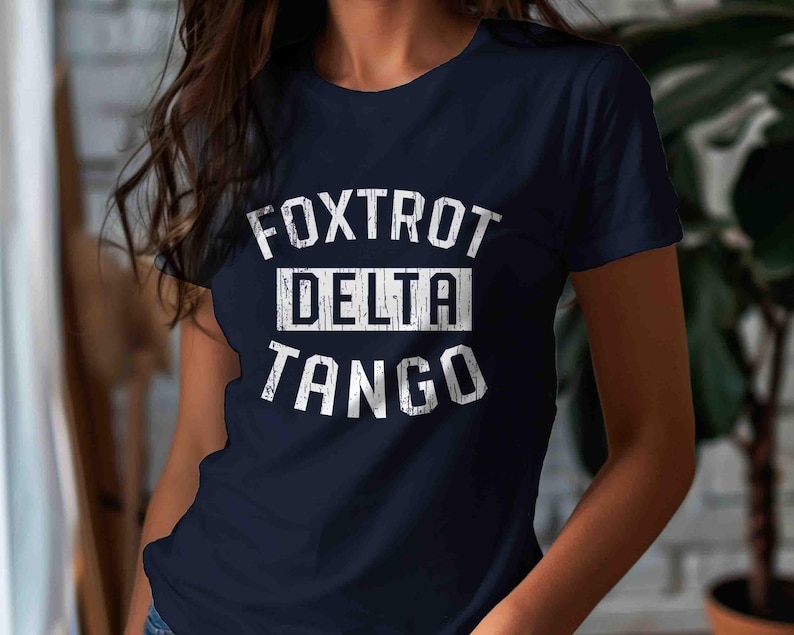 May include: A navy blue t-shirt with white text that reads "FOXTROT DELTA TANGO".