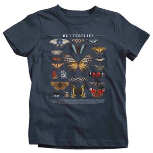 May include: A navy blue t-shirt with a graphic of various butterflies. The butterflies are numbered and labeled with their scientific names. The text "Butterflies" is printed at the top of the graphic.