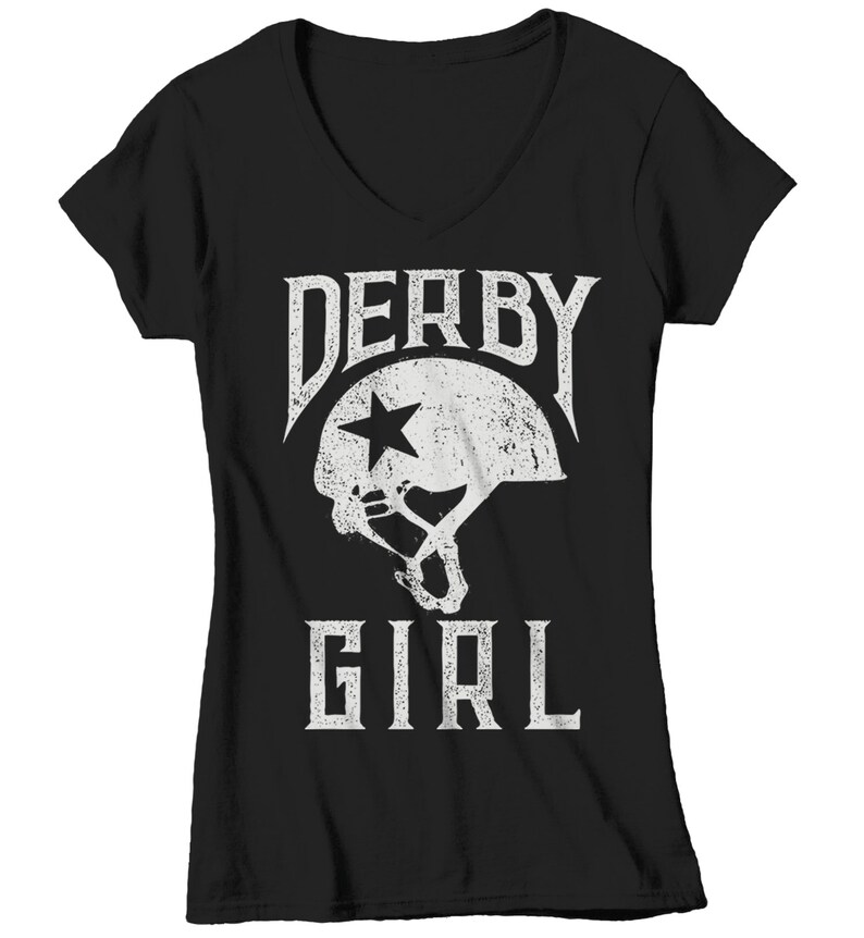May include: Black v-neck t-shirt with a white graphic of a roller derby helmet with a star and the text "Derby Girl".