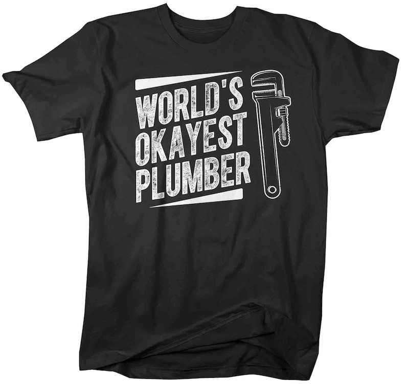 May include: Black t-shirt with white text that reads "World's Okayest Plumber" and a white wrench graphic.