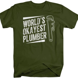 May include: A green t-shirt with the text "World's Okayest Plumber" in white with a white wrench graphic.