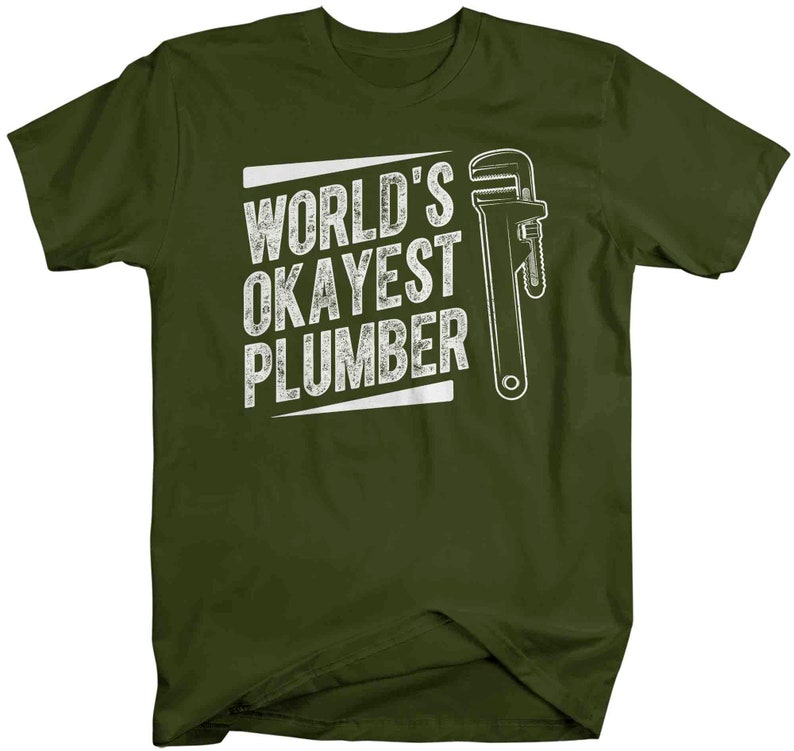 May include: A green t-shirt with the text "World's Okayest Plumber" in white with a white wrench graphic.