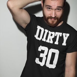 May include: A black t-shirt with white text that reads "DIRTY 30".