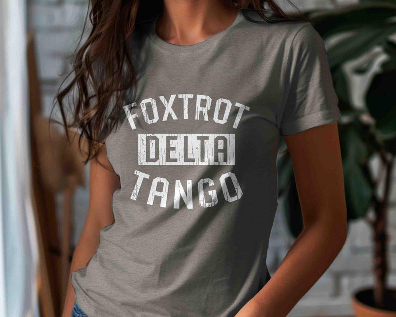 May include: Gray t-shirt with white text that reads "FOXTROT DELTA TANGO".