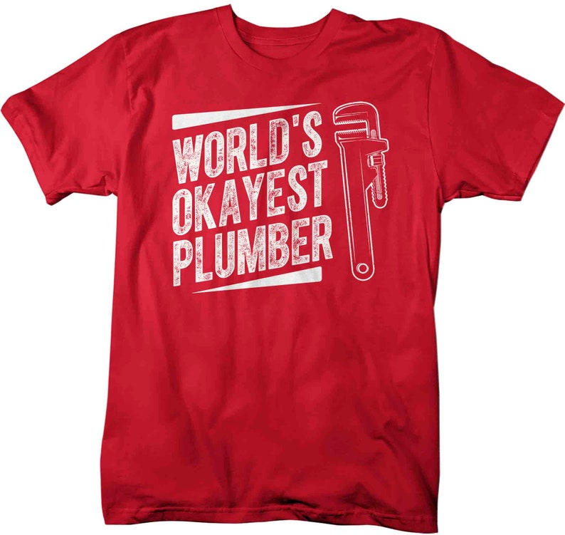 May include: Red t-shirt with white text that reads "World's Okayest Plumber" and a white wrench graphic.