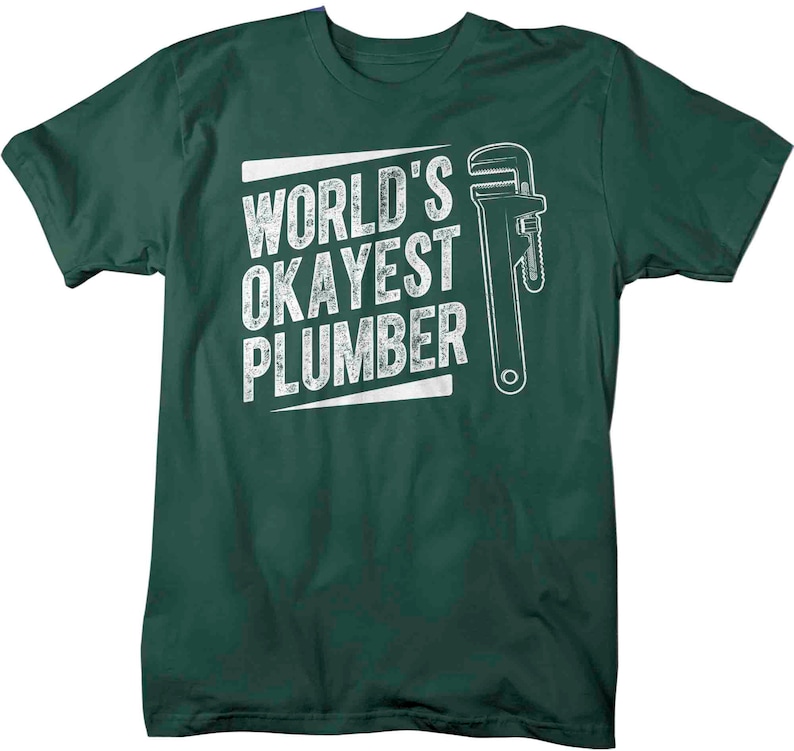 May include: A dark green t-shirt with a white graphic of a wrench and the text "World's Okayest Plumber".