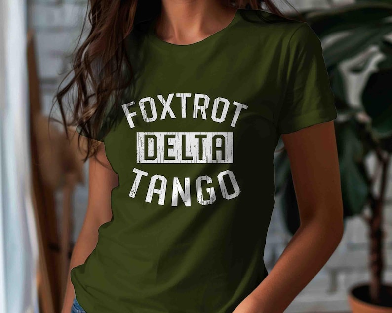 May include: A green t-shirt with a white graphic print that says "FOXTROT DELTA TANGO".