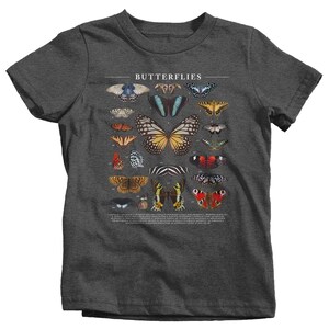May include: A dark heather grey t-shirt with a graphic print of butterflies. The text "Butterflies" is printed at the top of the graphic. The graphic includes 20 different butterflies with numbers and names.