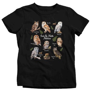 May include: Black t-shirt with a graphic of different types of owls from North America. The owls are illustrated in a watercolor style with their names listed below each one. The text "Owls of North America" is printed in the center of the shirt.
