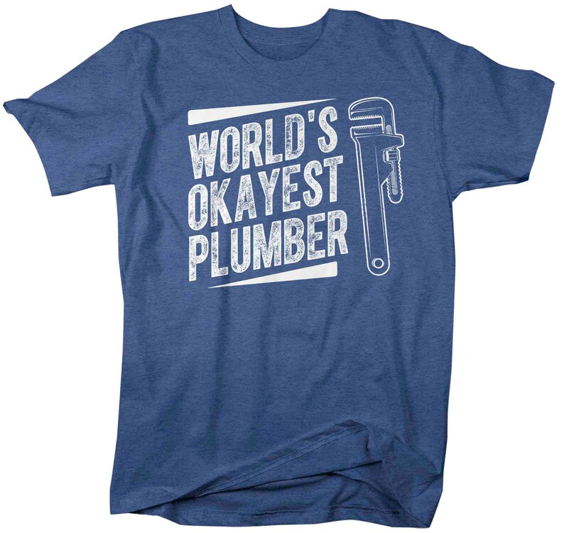May include: A blue t-shirt with white text that reads "World's Okayest Plumber" and a white wrench graphic.