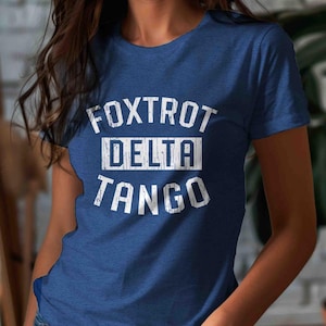 May include: A blue t-shirt with white text that reads "FOXTROT DELTA TANGO".