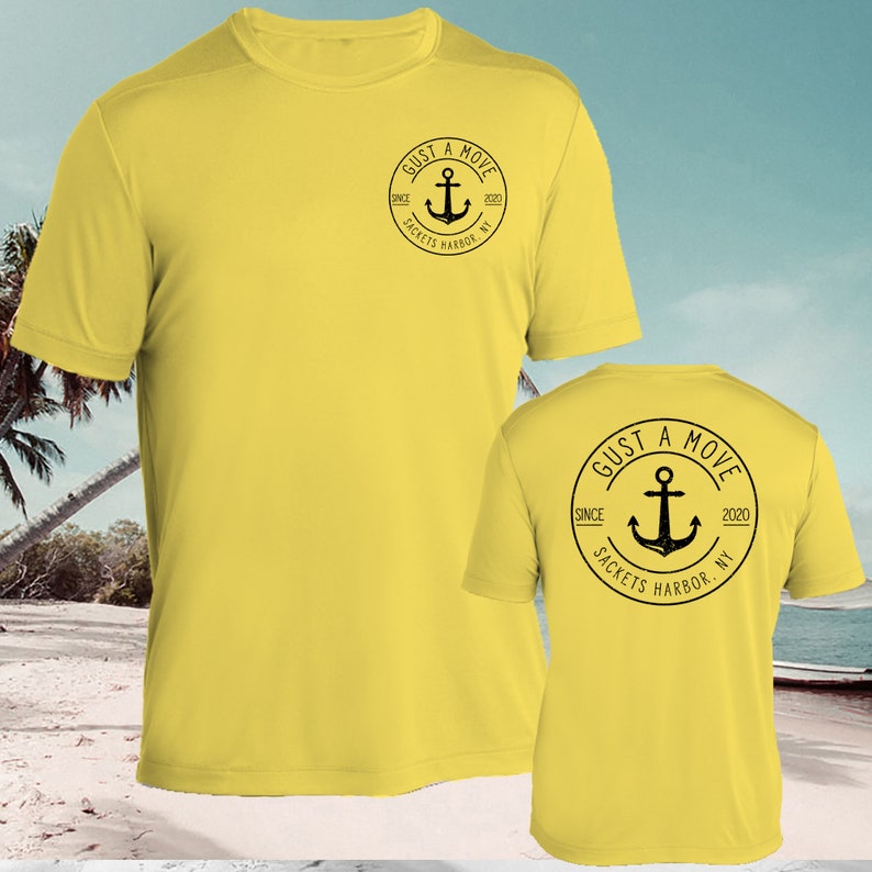 May include: Yellow short-sleeved t-shirt with a black circle logo on the front and back. The logo says "Just a Move" with an anchor and the text "Since 2020 Sackets Harbor, NY".